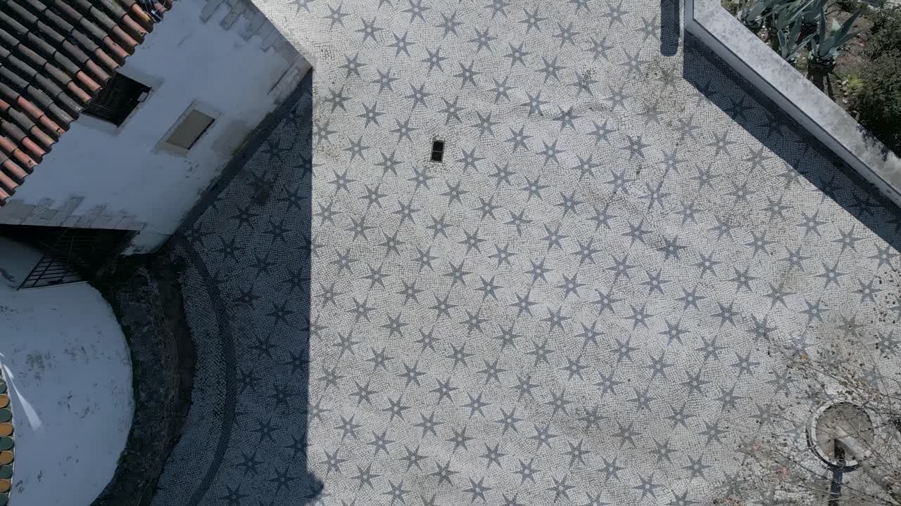aerial view of tourists walking on the traditional Lisbon floor, featuring the city's typical ornaments and patterns