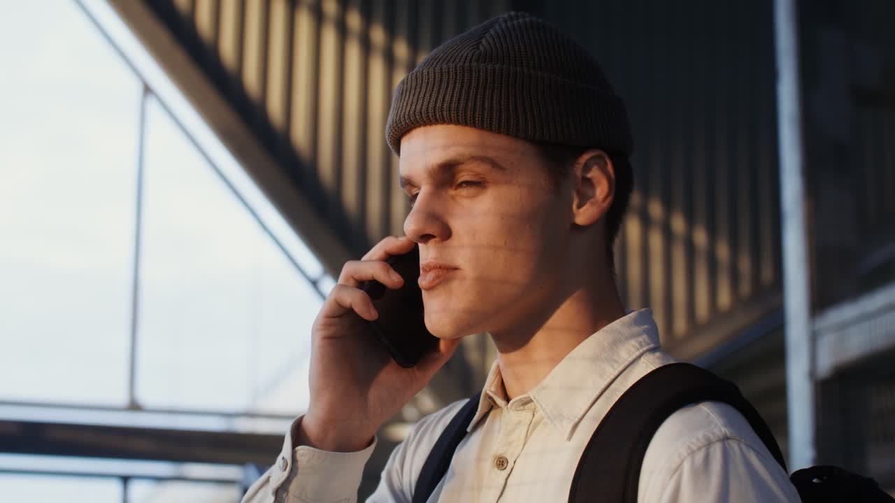 밖에서 전화로 얘기하는 젊은 남자