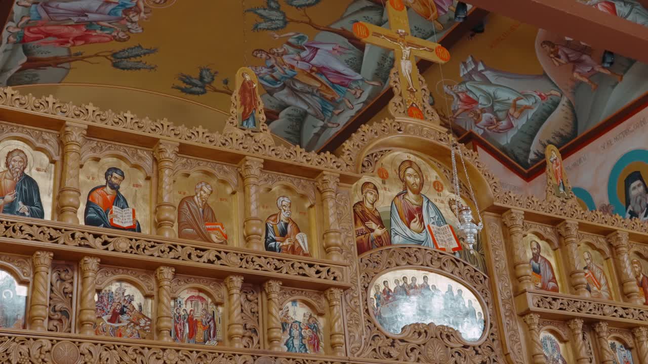 Ornate Orthodox Iconostasis with Religious Artwork and Byzantine-Style Imagery in Eastern Christian Church Interior. Chicago, Illinois, USA.