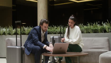 young man and woman having a meeting in the hotel hall