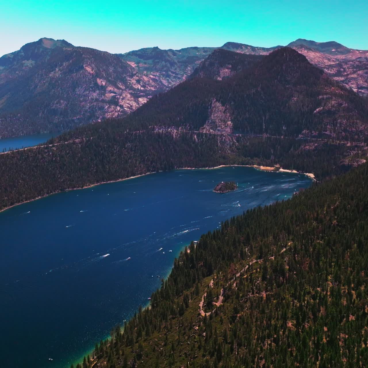 Tremendous view of beautiful Lake Tahoe surrounded by Sierra Nevada mountains. Stunning wildlife panorama at the backdrop of blue sky