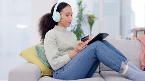 Woman,-headphones-and-credit-card-on-tablet