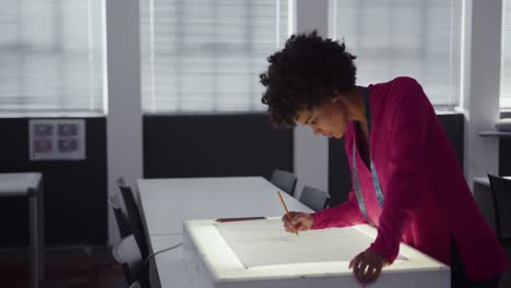 mixed race woman working in fashion office