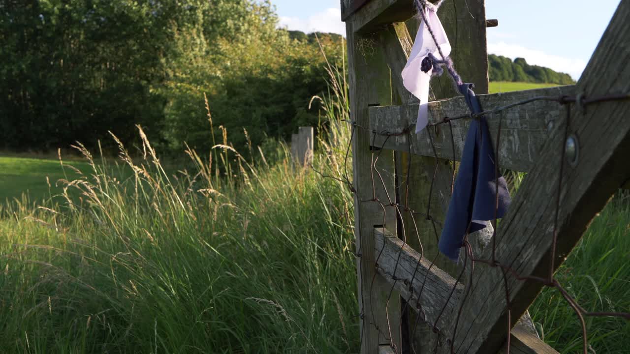 Wooden gate in farmers field wide landscape shot