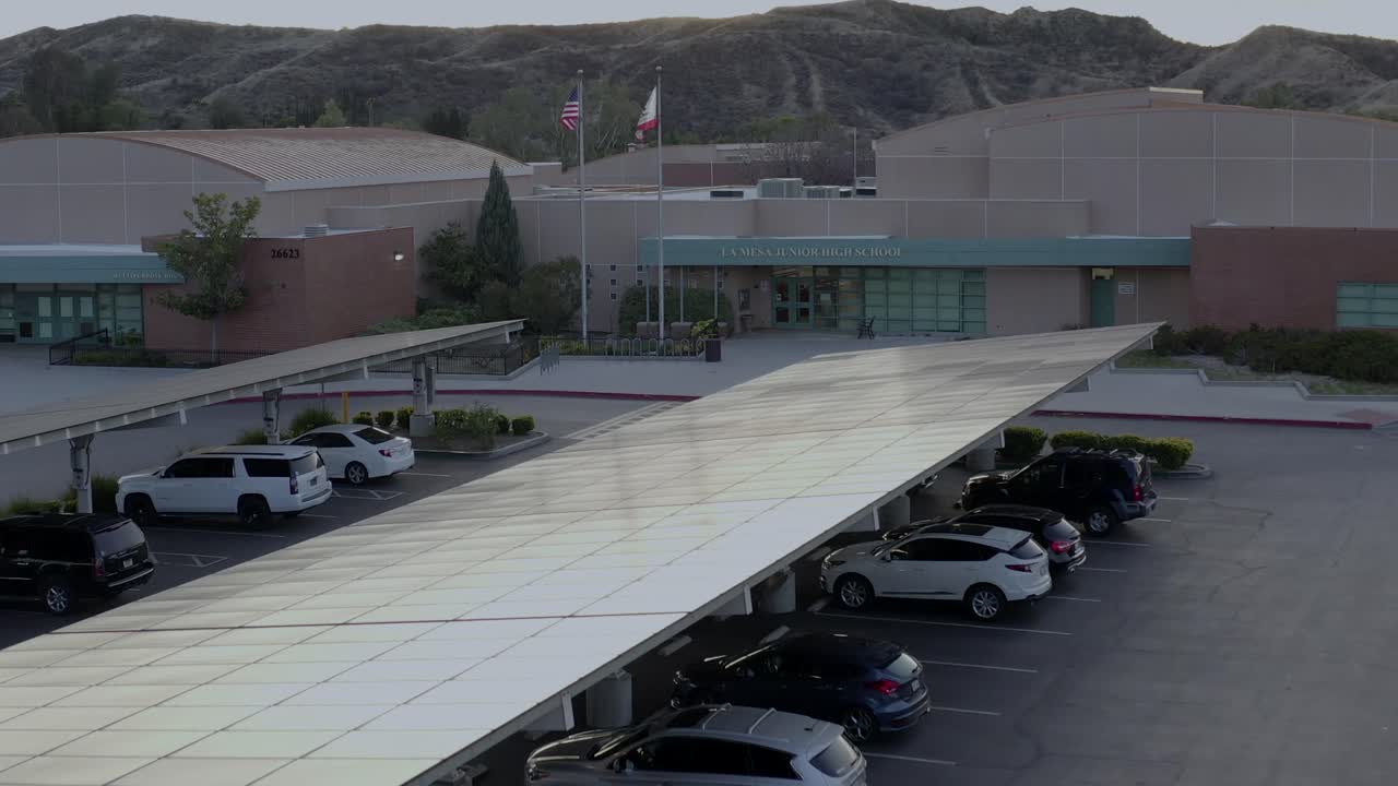 Aerial, rising, drone shot, over La mesa junior high school, at sunset, in Santa Clarita, California, USA