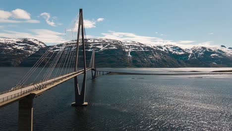 4k drone wide shot with parallax motion of calm fjord and the majestic bridge in helgeland, a famous tourist attraction on the norwegian scenic tourist route helgelandskysten, helgelandsbrua, norway