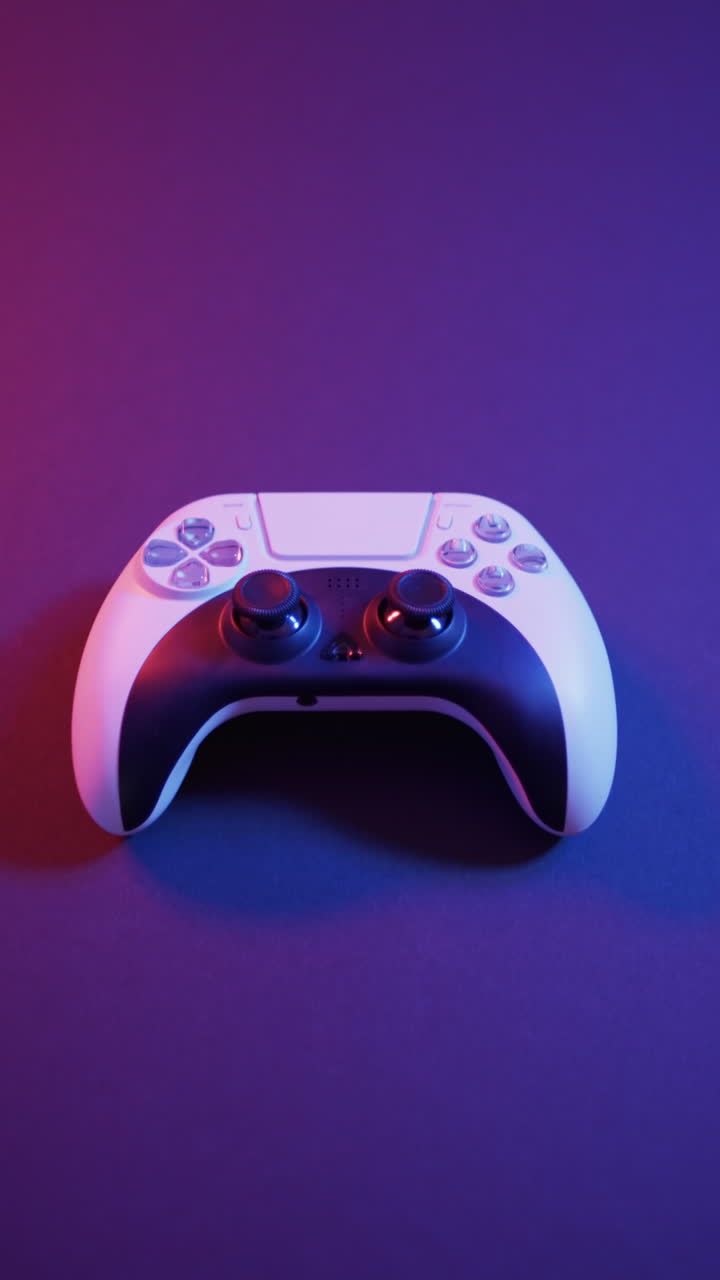 Vertical video of video game pad on purple neon background