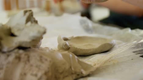 close-up of artist molding a clay at table 4k