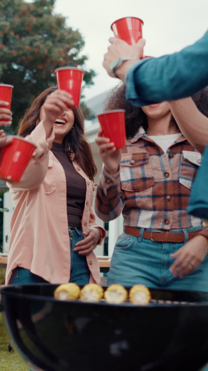 Happy Friends Cheering with Red Cups at an Outdoor Barbecue Party