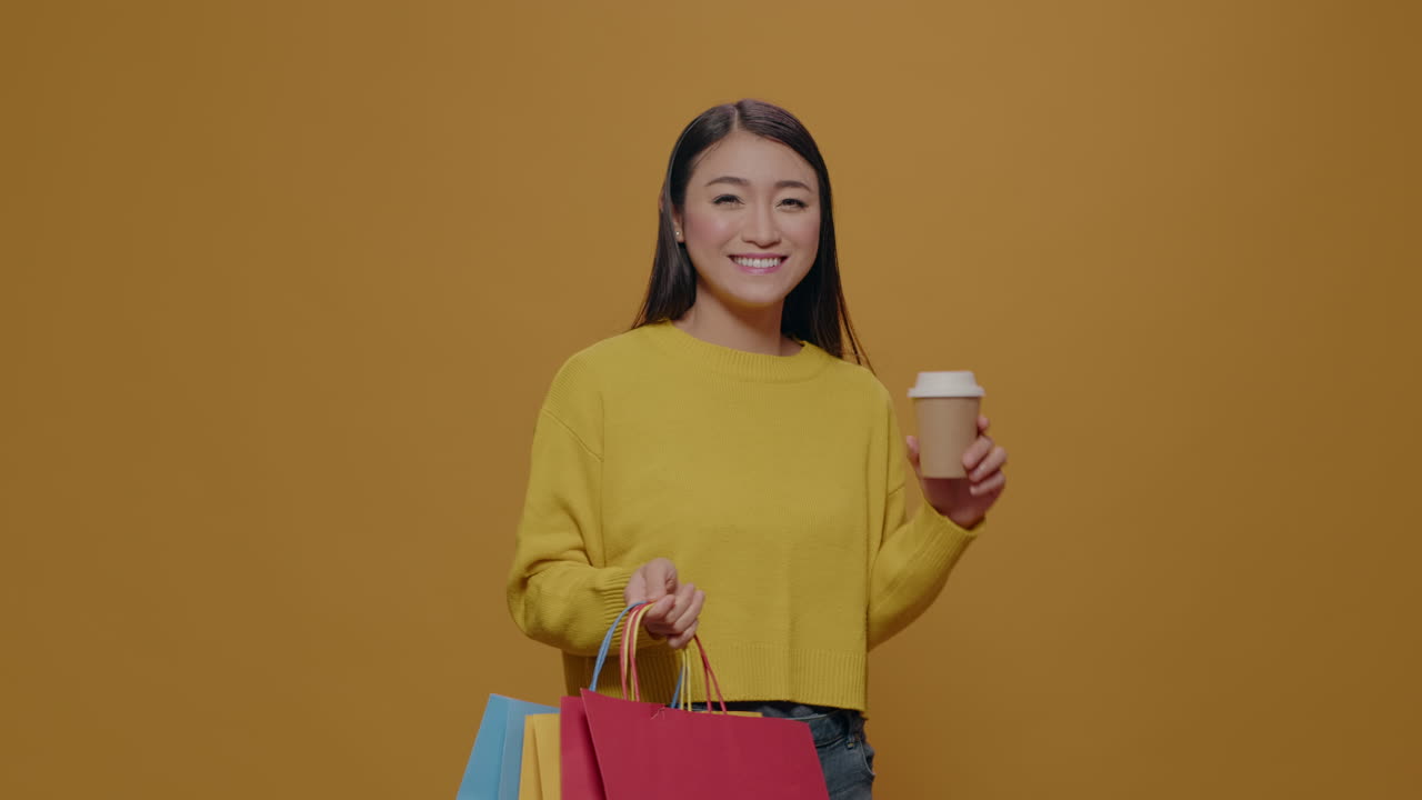Young woman carrying shopping bags after retail purchase