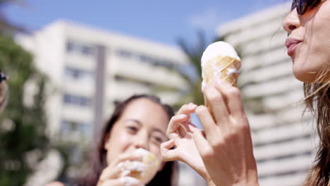 Close-up-portrait-teenage-girls-eating-ice-cream-in-the-summer-on-vacation