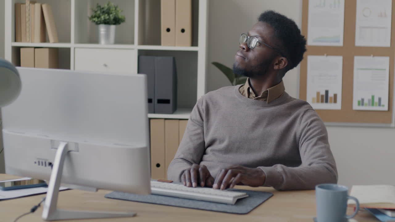 African American Man Working at a Computer in an Office