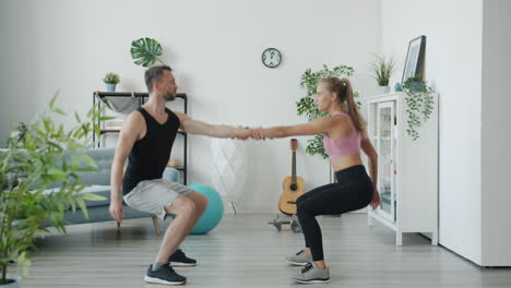 couple doing squats at home