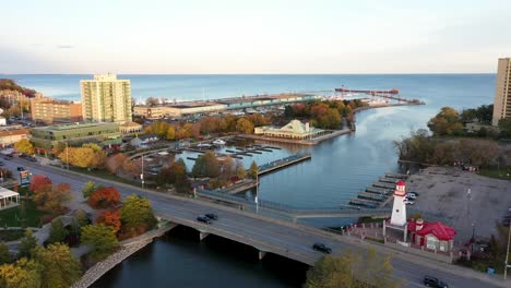 Drone-circling-over-a-lighthouse-in-a-Mississauga-harbor-at-sunrise