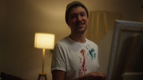 smiling artist painting at home