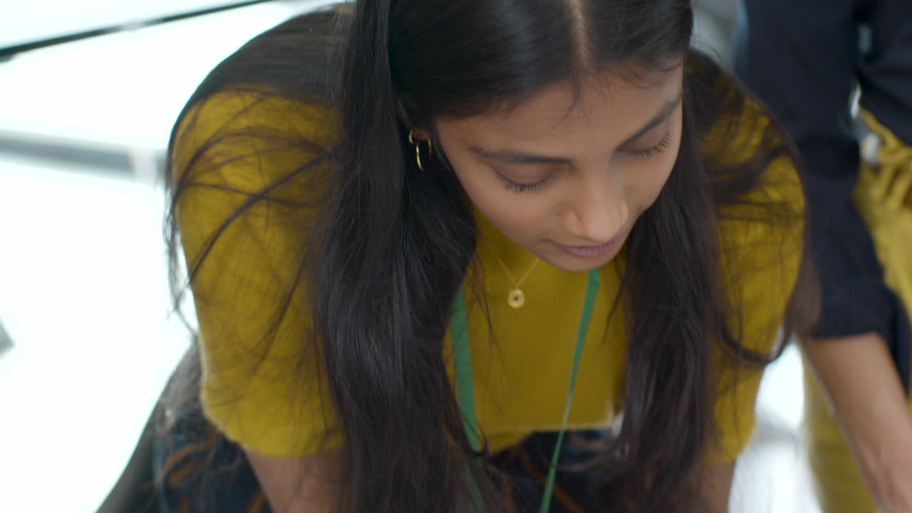 Close Up Of Businesswoman Talking And Writing In Meeting
