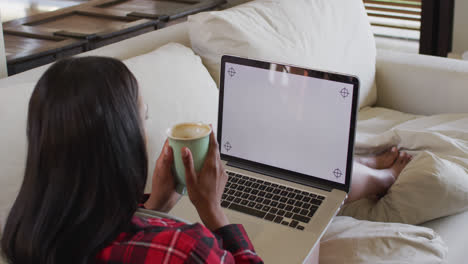 Mixed-race-woman-on-couch-at-home