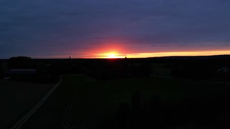 dramatic golden orange sunset sky with silhouette landscape view