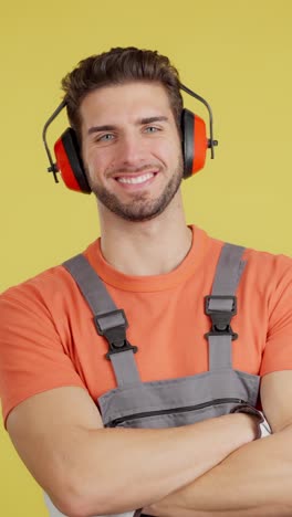 smiling man in ear protection and overalls