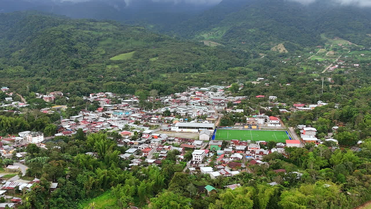 Aerial View of a Small Town Nestled in Lush Green Mountains