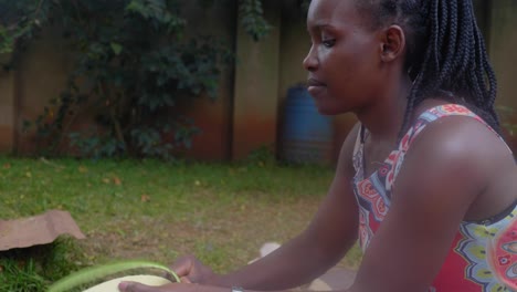 close shot of an african woman peeling a traditional local type of african banana for eating
