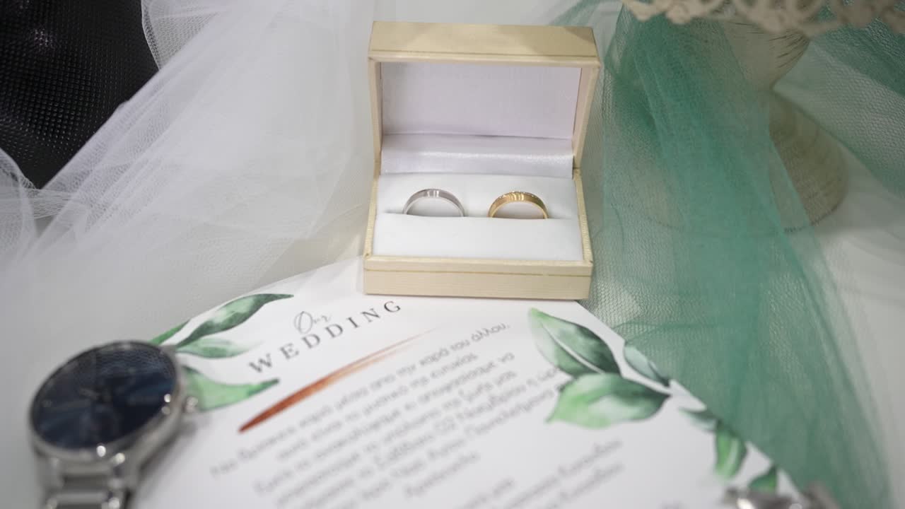 Wedding rings and invitation displayed on a soft background in elegant setting