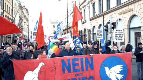 anti war and anti military protest in germany. german banners translate into pro peace statements. thousands of people in the streets