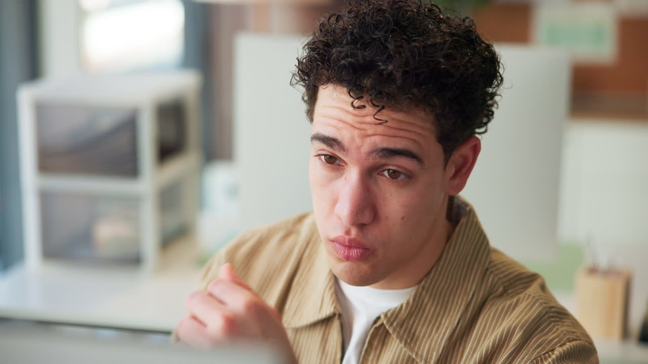 Young Man Rubbing Tired Eyes While Working in Office