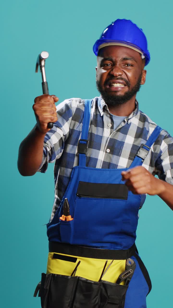 Vertical video: Construction worker hitting something with hammer