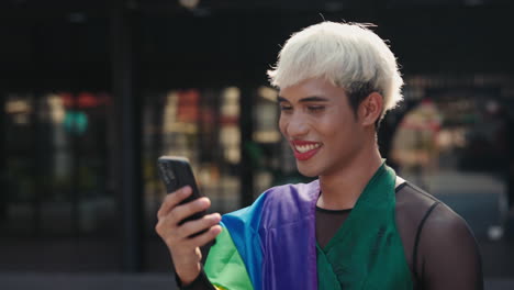 smiling man using phone, pride flag