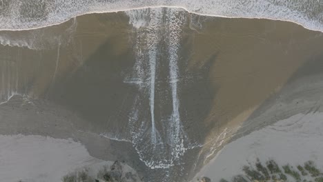 Aerial-Top-Down-Drone-shot-of-High-Tide-rivers-at-Pismo-Beach-California-at-Sunrise