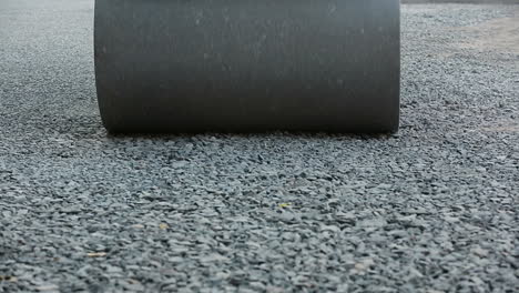 Road roller laying gravel during road construction