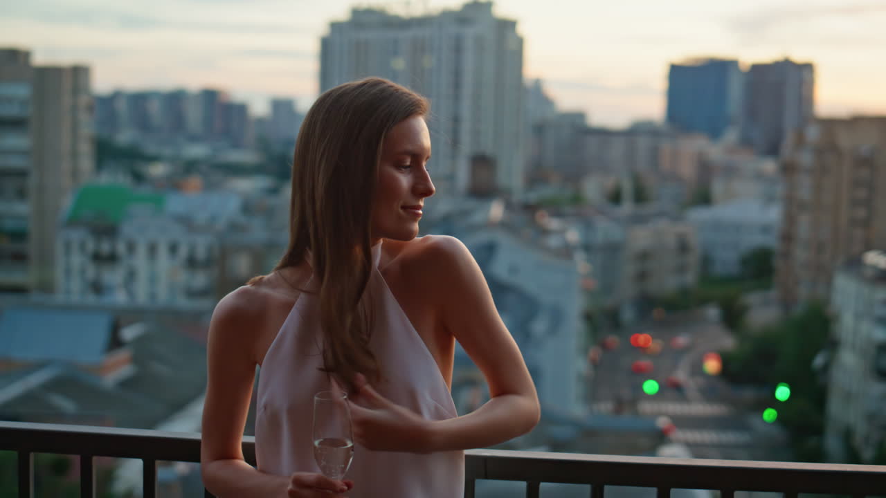 Relaxed lady resting terrace restaurant holding champagne at evening closeup