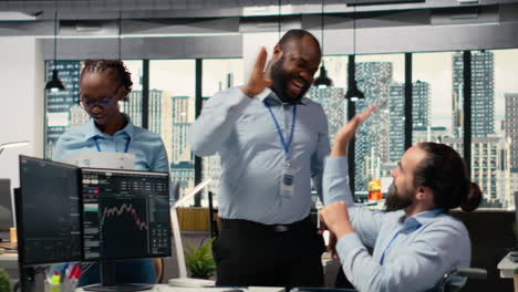 happy worker with paraplegia and prop firm colleague doing high five