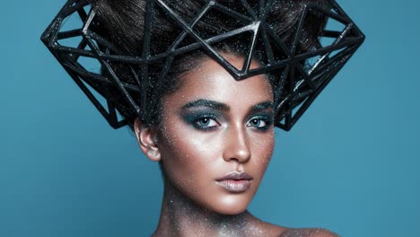 a stunning portrait of modern beauty: this frame captures an artistic representation of fashion with intricate geometric headpiece and glamorous make-up