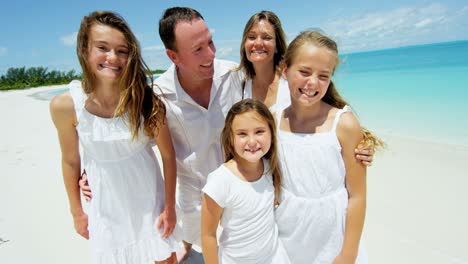 smiling portrait of caucasian family together by ocean