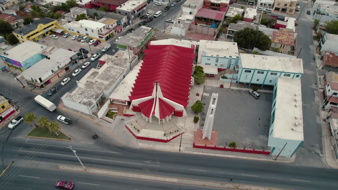 Aerial over church San P&iacute;o X at Reynosa, Tamaulipas, road with traffic near by, video sequence promoting religious and spirituality concept