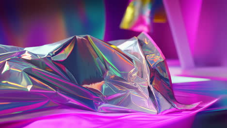 abstract holographic material on vibrant pink background