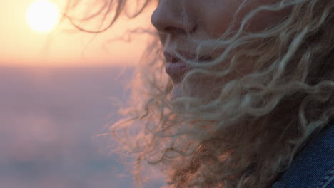 close up portrait of beautiful woman enjoying peaceful seaside at sunset contemplating journey exploring spirituality feeling freedom with wind blowing hair