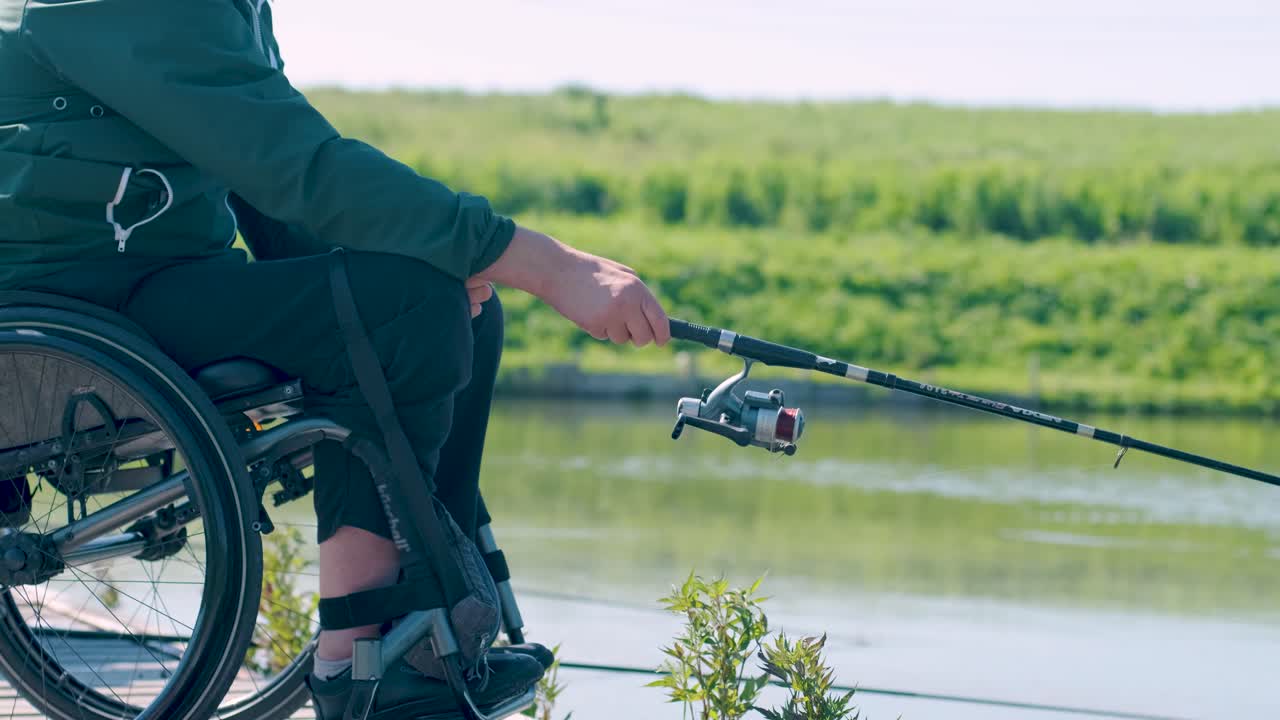 Man with disabilities fishing at a lake. Wheelchair. Camping. Summertime