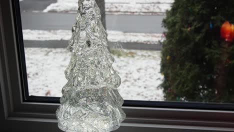 tilt up on christmas tree light with floating confetti inside
