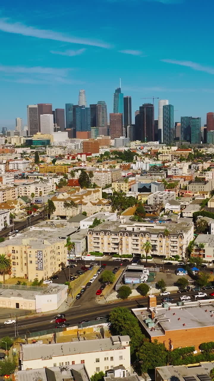 Amazing bright sunny picture of Los Angeles, California, USA. Drone rising over the cityscape. Skyscrapers at backdrop. Vertical video