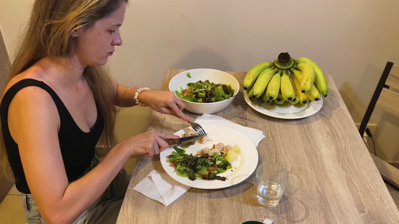 Woman Eating Salad and Bananas