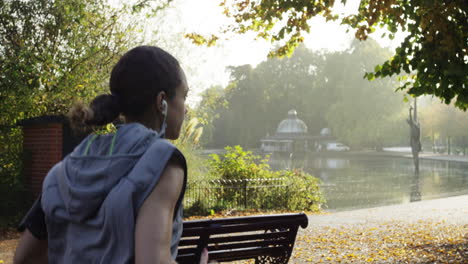 runner woman running in park exercising outdoors fitness tracker wearable technology