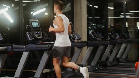 man running on a treadmill in a gym