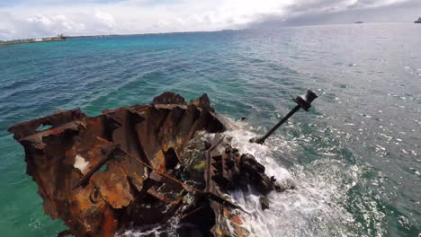 aerial over a rusting shipwreck in the harbor of tuvalu