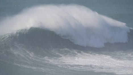 majestic waves crashing at nazare, portugal, with surfers navigating the ocean's power