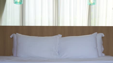 Hotel-bed-with-white-sheets-and-two-pillows