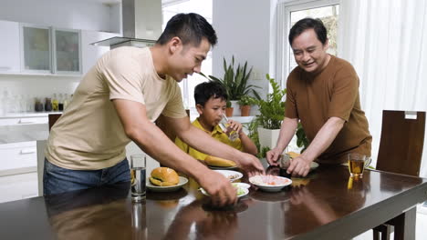 asian men and boy sitting at the table