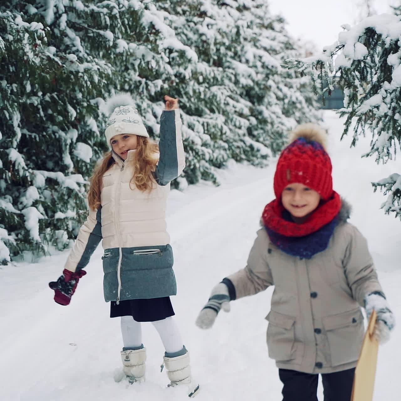 Children play outdoors in snow. Outdoor fun for family Christmas vacation.
